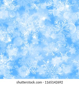 Christmas seamless pattern with white blurred snowflakes, glare and sparkles on light blue background