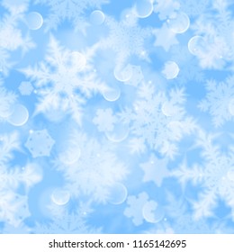 Christmas seamless pattern with white blurred snowflakes, glare and sparkles on light blue background