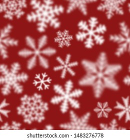 Christmas seamless pattern of white defocused snowflakes on red background