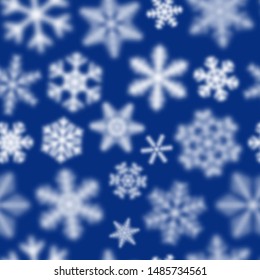 Christmas seamless pattern of white defocused snowflakes on blue background