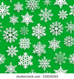 Christmas seamless pattern with white paper snowflakes on green background