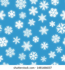 Christmas seamless pattern of white snowflakes of different shapes on light blue background