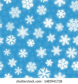 Christmas seamless pattern of white snowflakes of different shapes on light blue background
