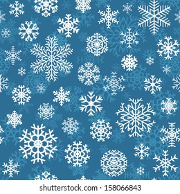 Christmas seamless pattern from white snowflakes on blue background