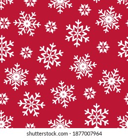 Patrón ininterrumpido de Navidad copos de nieve blancos sobre fondo rojo