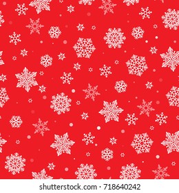 Christmas seamless pattern with white snowflakes on red background. Winter New Year pattern.