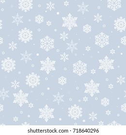 Christmas seamless pattern with white snowflakes on blue background. Winter New Year pattern.