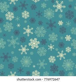 Christmas seamless pattern with yellow and blue snowflakes on green background