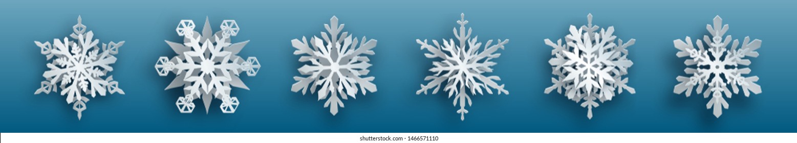 Christmas set of white complex paper snowflakes with soft shadows on light blue background