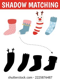 Christmas shadow matching activity for children. Winter puzzle with cute socks. New Year educational game for kids. Find the correct silhouette printable worksheet.