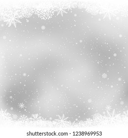 Christmas snow frame on gray background. Snowfalls winter sky clouds. Frosty close-up wintry snowflakes. Ice shape pattern. Christmas holiday decoration backdrop