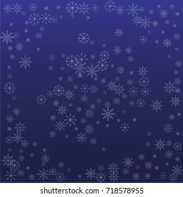 Christmas snow powder background of a random scatter snowflakes on a blue background. Snow explosion. Ice storm.