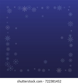 Christmas snow powder frame or border of a random scatter snowflakes on a blue background. Snow explosion. Ice storm.