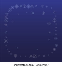 Christmas snow powder frame or border of a random scatter snowflakes on a blue background. Snow explosion. Ice storm.