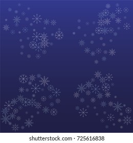 Christmas snow powder frame or border of a random scatter snowflakes on a blue background. Snow explosion. Ice storm.