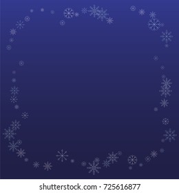 Christmas snow powder frame or border of a random scatter snowflakes on a blue background. Snow explosion. Ice storm.