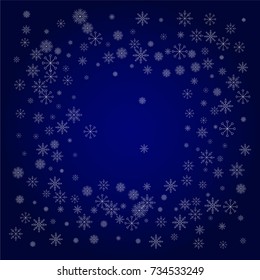 Christmas snow powder frame or border of a random scatter snowflakes in blue. Snow explosion. Ice storm.