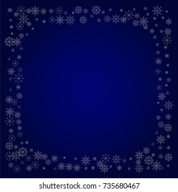 Christmas snow powder frame or border of a random scatter snowflakes in blue. Snow explosion. Ice storm.