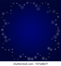 Christmas snow powder frame or border of a random scatter snowflakes in blue. Snow explosion. Ice storm.
