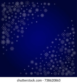 Christmas snow powder frame or border of a random scatter snowflakes in blue. Snow explosion. Ice storm.