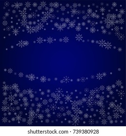 Christmas snow powder frame or border of a random scatter snowflakes in blue. Snow explosion. Ice storm.