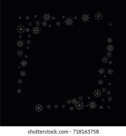 Christmas snow spray frame or border of a random scatter snowflakes isolated on black. Snow explosion. Ice storm.