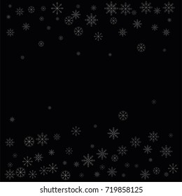Christmas snow spray frame or border of a random scatter snowflakes isolated on black. Snow explosion. Ice storm.