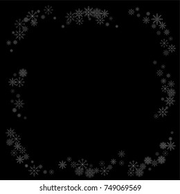 Christmas snow spray frame or border of a random scatter snowflakes isolated on black. Snow explosion. Ice storm.