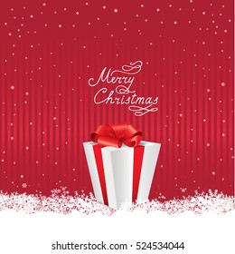 Christmas snowfall background with handwritten greeting lettering MERRY CHRISTMAS and gift box
