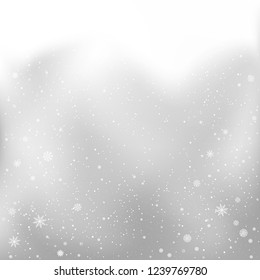 Christmas snowfall on clouds sky backdrop. Winter snowfall on gray background. Frosty close-up wintry snowflakes. Ice shape pattern
