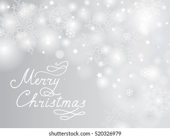 Christmas snowflake blur background with Snow and Handwritten Greeting Lettering MERRY CHRISTMAS.