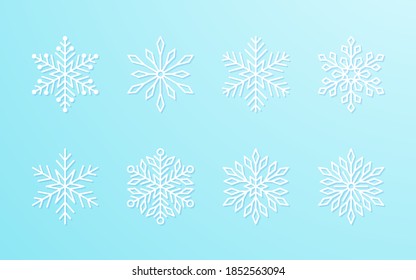 Christmas snowflakes collection white isolated on blue gradient background. Cute snow icons with intricate silhouette. Nice line doodle decorative element for New year banner, cards or ornament.