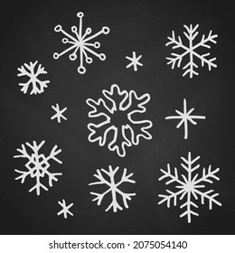 Christmas snowflakes hand drawn doodle design elements vector illustration. Winter holidays greeting card items set over black chalkboard.