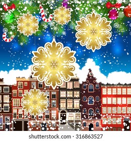 Christmas snowflakes on the background of snow-covered streets. Green branches of Christmas trees decorated with Christmas balls and sweets. Christmas background.