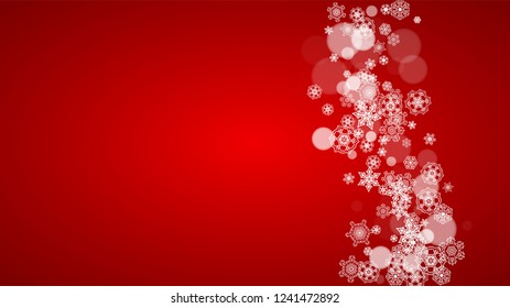 Christmas snowflakes on red background. Santa Claus colors. Horizontal Christmas snowflakes frame for holiday banners, cards, sales, special offers. Falling snow with bokeh for party celebration