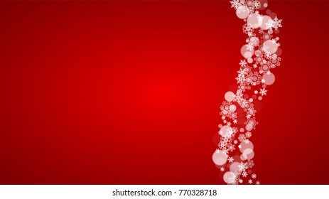 Christmas snowflakes on red background. Santa Claus colors. Horizontal Christmas snowflakes frame for holiday banners, cards, sales, special offers. Falling snow with bokeh for party celebration