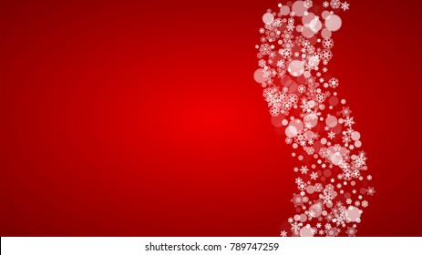 Christmas snowflakes on red background. Santa Claus colors. Horizontal Christmas snowflakes frame for holiday banners, cards, sales, special offers. Falling snow with bokeh for party celebration