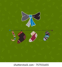 Christmas socks and bow in green background