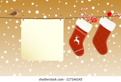 Christmas socks full of candies hanged on a clothesline next to a piece of paper