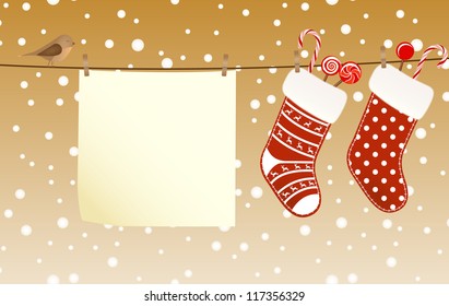Christmas socks full of candies hanged on a clothesline next to a piece of paper