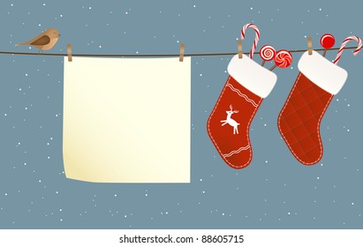 Christmas socks full of candies hanged on a clothesline next to a piece of paper