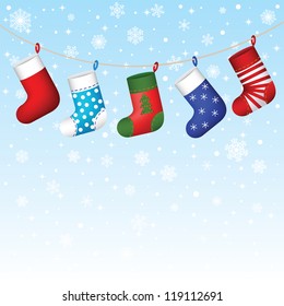 Christmas socks hanging on snowflakes background