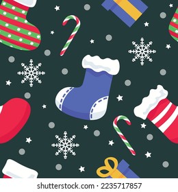 Christmas socks with snow and decorations on dark background. Pa