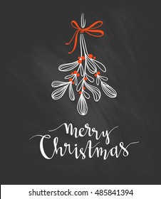 Christmas sprig of mistletoe with holiday lettering - Merry Christmas.  Vector illustration on the black chalkboard for greeting cards, invitations, and other printing projects.