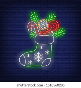 Christmas stocking neon sign. Fir tree, sweets, candies. Vector illustration in neon style for topics like Xmas, dessert, gifts