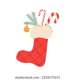 A Christmas stocking with sweets and a branch of a сhristmas tree. Flat cartoon vector illustration.