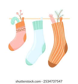 Christmas stocking with sweets and a twig, in flat vector style. Gift stocking hanging over the fireplace isolated on a white background. Christmas symbols