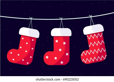 Christmas stockings hanging on a wire with starry sky background