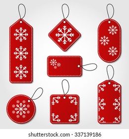 Christmas tag collection in red and white color. Red tag vector set in different shapes with snowflake design and hangers for price tags or gift cards.