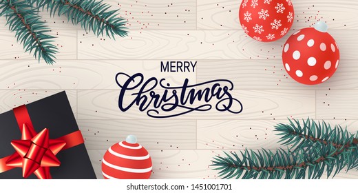 Christmas template for banners, cards or posters in realistic style. Vector illustration with present box, spruce branches and ornaments on a wooden background